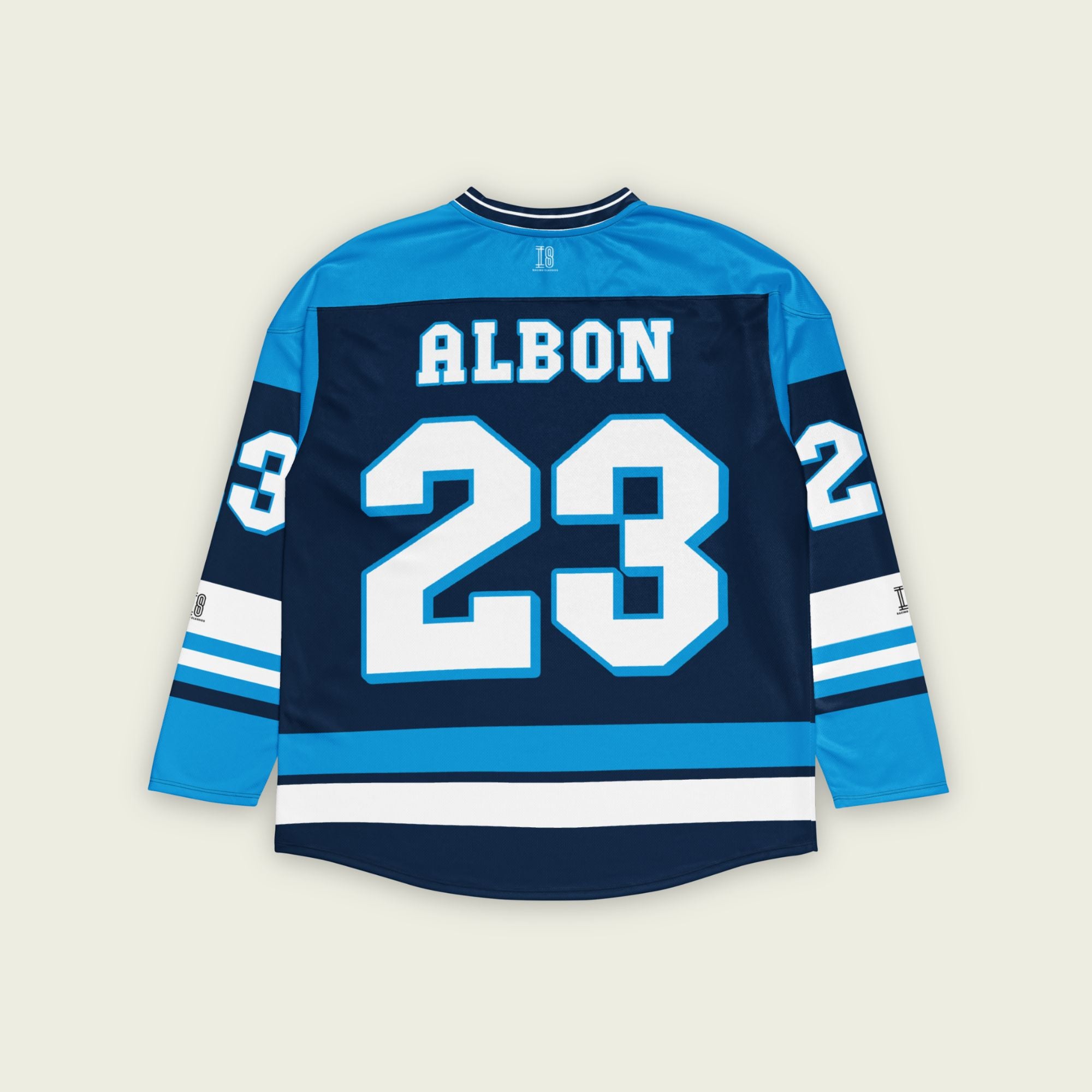 A blue hockey jersey with Alex Albon's Williams F1 racing number 23 on the front and back in white, also the name Albon is on the back and front in White.