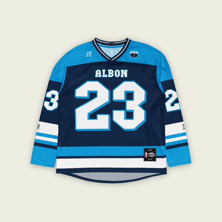 A blue hockey jersey with Alex Albon's Williams F1 racing number 23 on the front and back in white, also the name Albon is on the back and front in White.