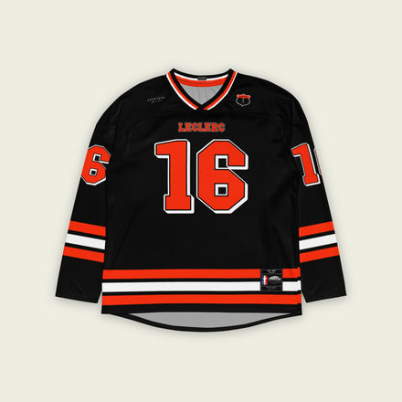 A black hockey jersey with red and white stripes on the bottom and the arms. It has Charles Leclerc's Ferrari F1 racing number 16 on the front and the back with the name Leclerc just above each number