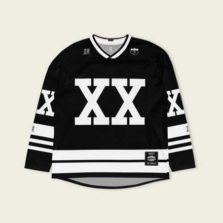 A Chris Brown Breezy Bowl Tour black and white hockey jersey with white lines showing the name Breezy on black on the back and XX on the front and back in white also. 