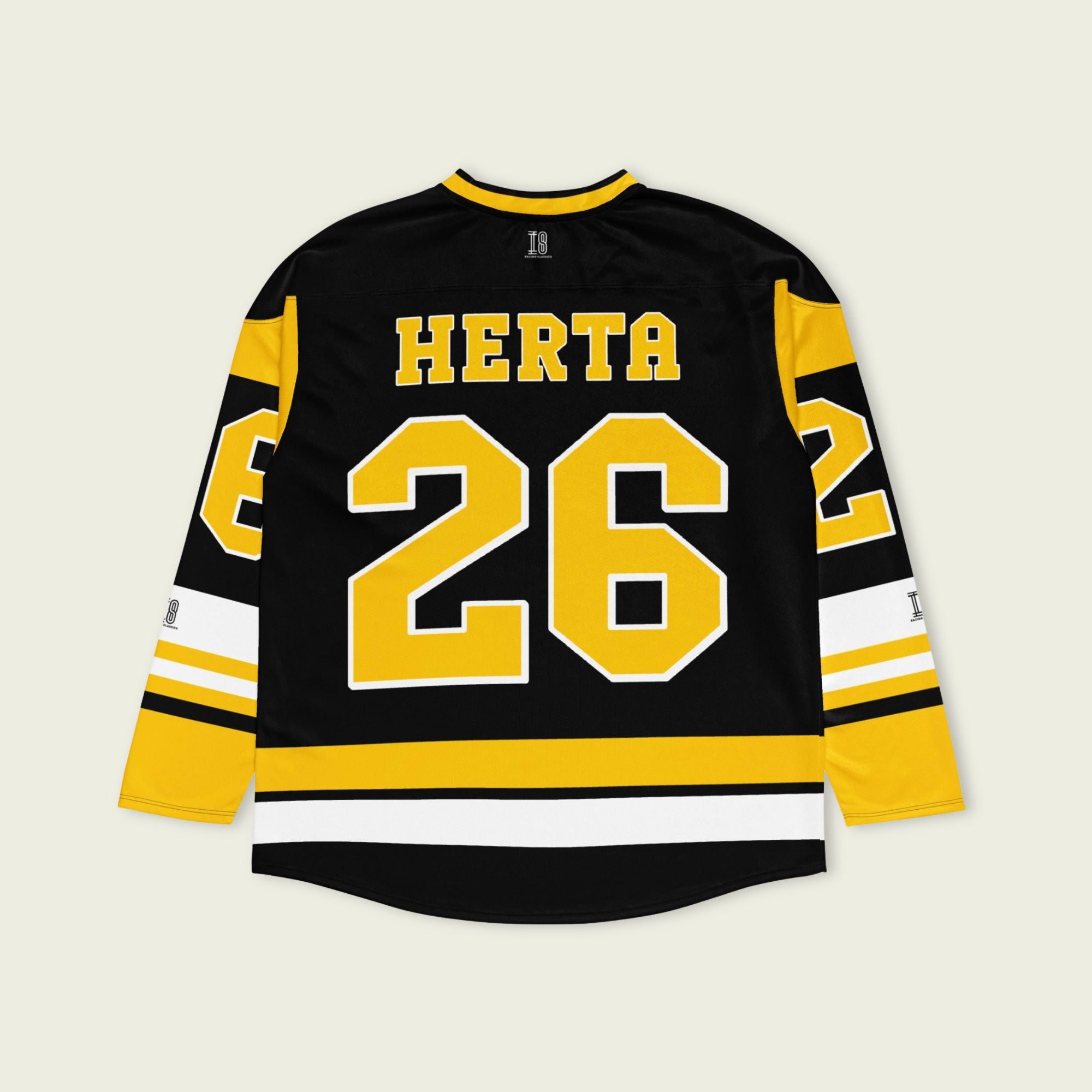 A black hockey jersey with yellow stipes at the bottom and the sleeves. It has the Indycar driver Colton Herta's race number 26 on the front and the back. It also has the name Herta on the front and the back both in yellow with a whilte outline.