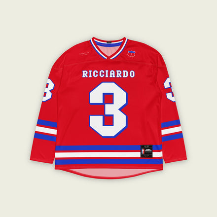 A red and blue hockey jersey with Daniel RIcciardo's redbull f1 racing number 3 on the front and back in white. It has the name Ricciardo in white on the front and back with a blue outline.