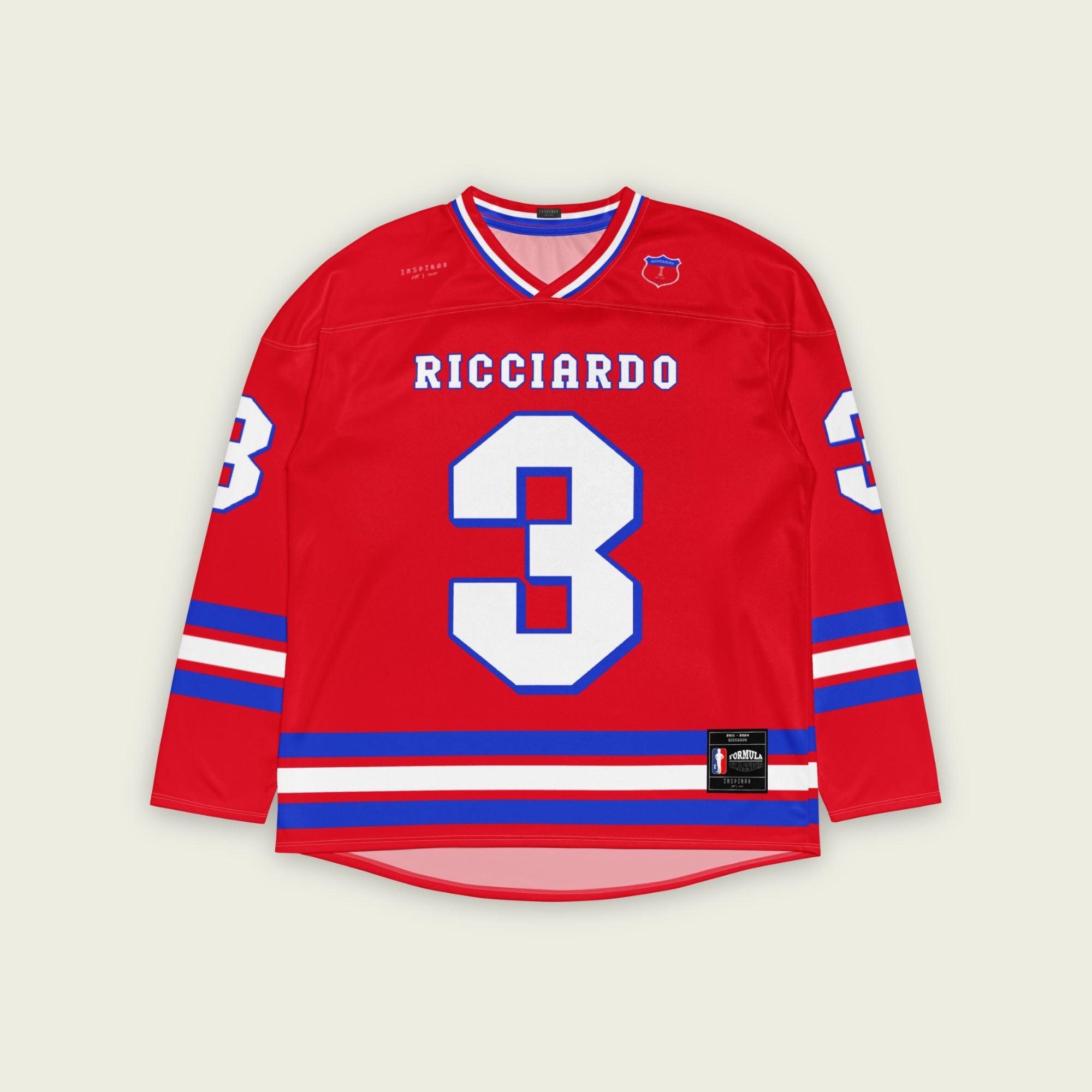A red and blue hockey jersey with Daniel RIcciardo's redbull f1 racing number 3 on the front and back in white. It has the name Ricciardo in white on the front and back with a blue outline.
