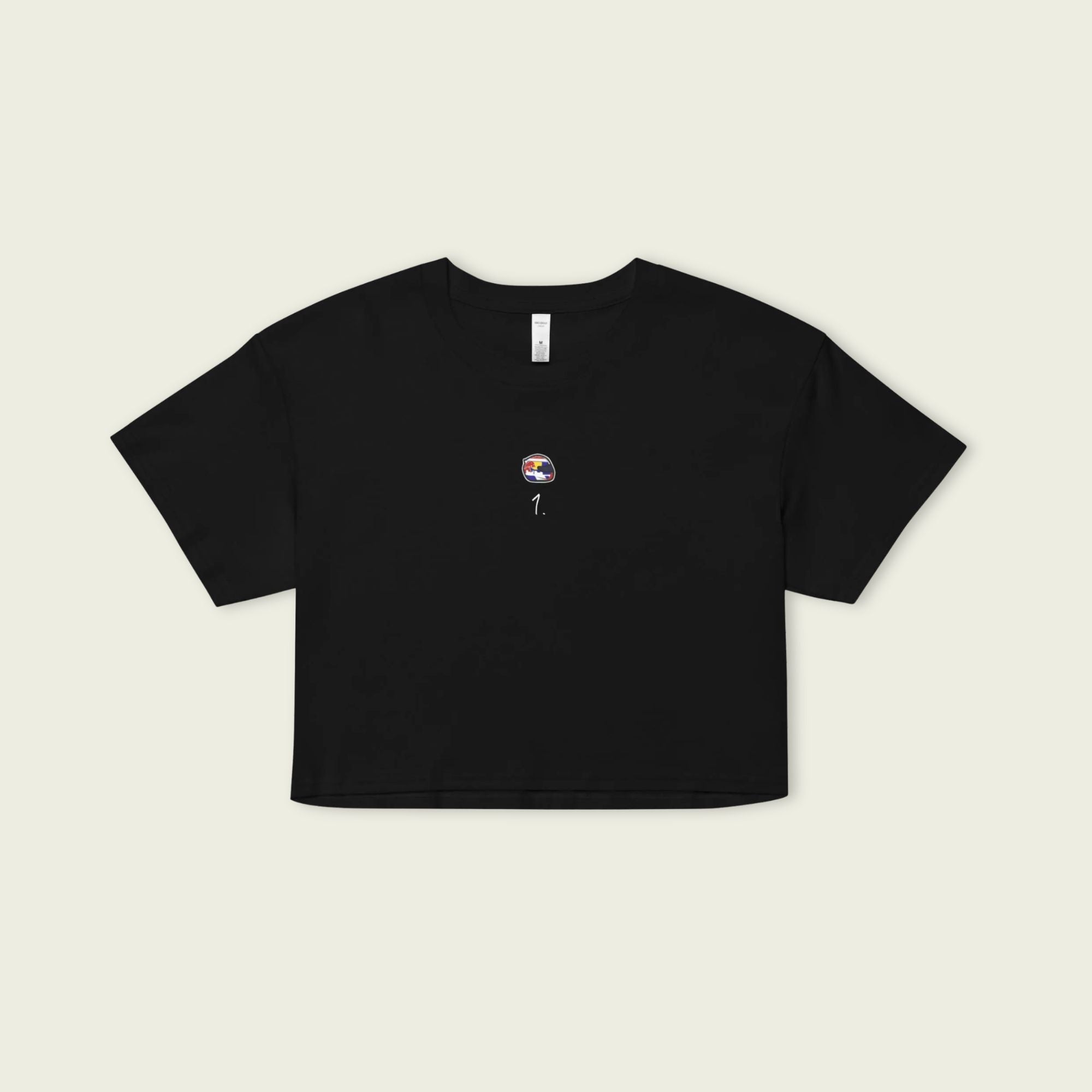 Black t-shirt with a small graphic on a beige background