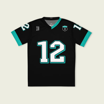 A black and AMG Green football jersey with Andrea Kimi Antonelli's Mercedes F1 racing number 12 on the back and front in white. It has the name Antonelli in green on the front and back as well.