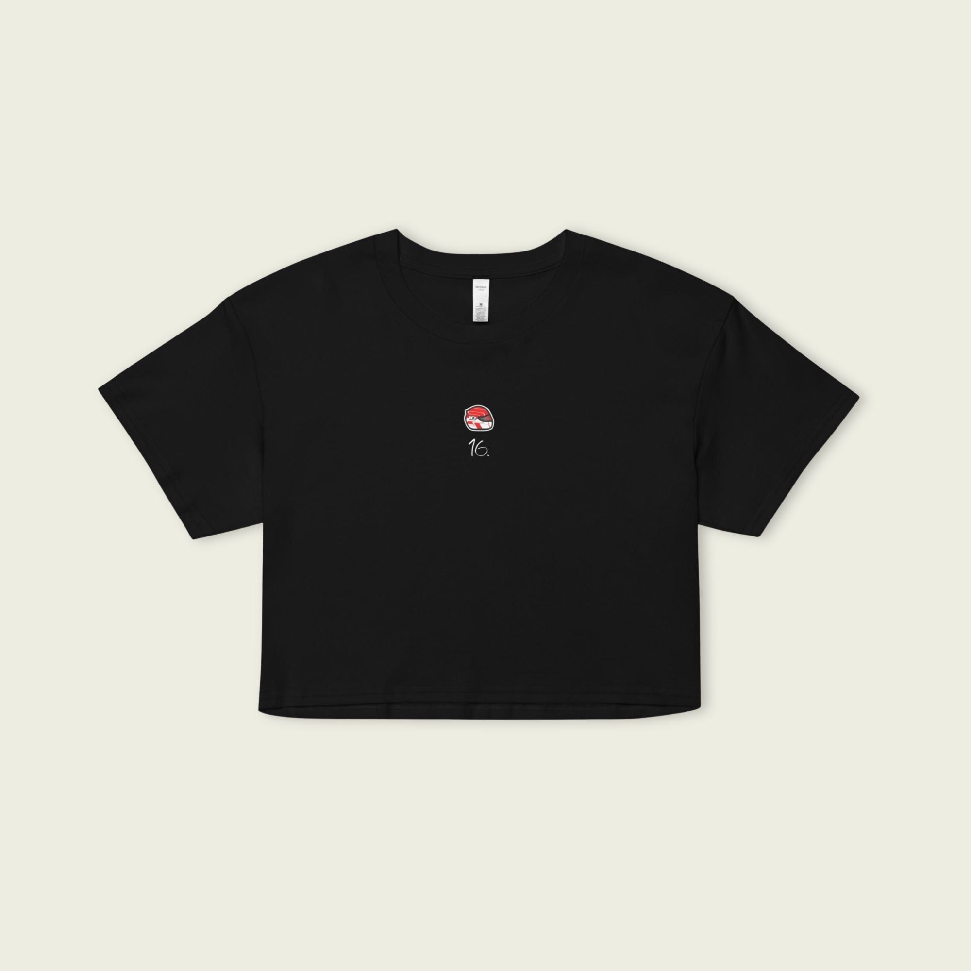 Black crop top with a small graphic on a beige background