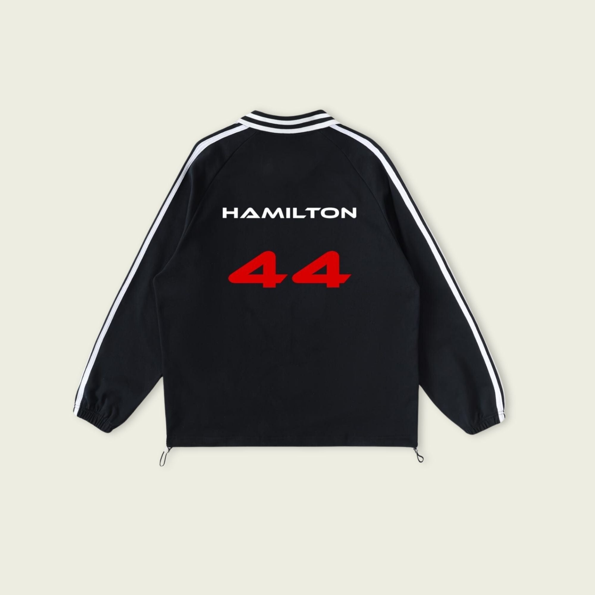 Black jacket with 'Hamilton 44' printed on the back against a beige background