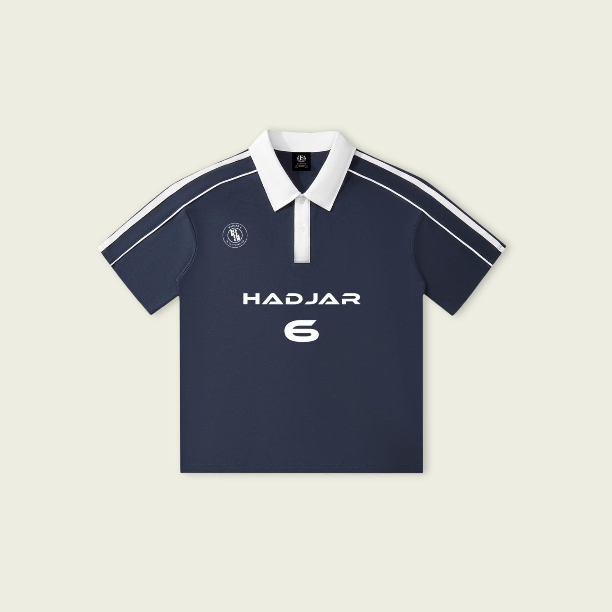 Navy blue polo shirt with white accents and branding on a beige background