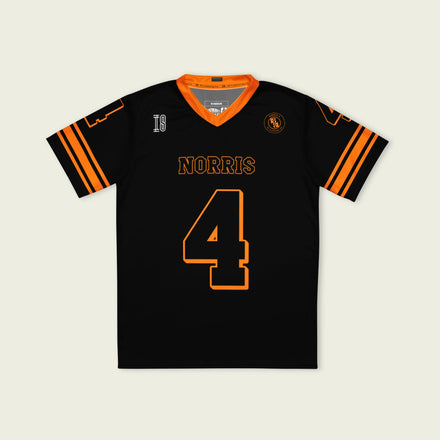 Black sports jersey with orange accents and 'Norris 4' printed on a light gray background