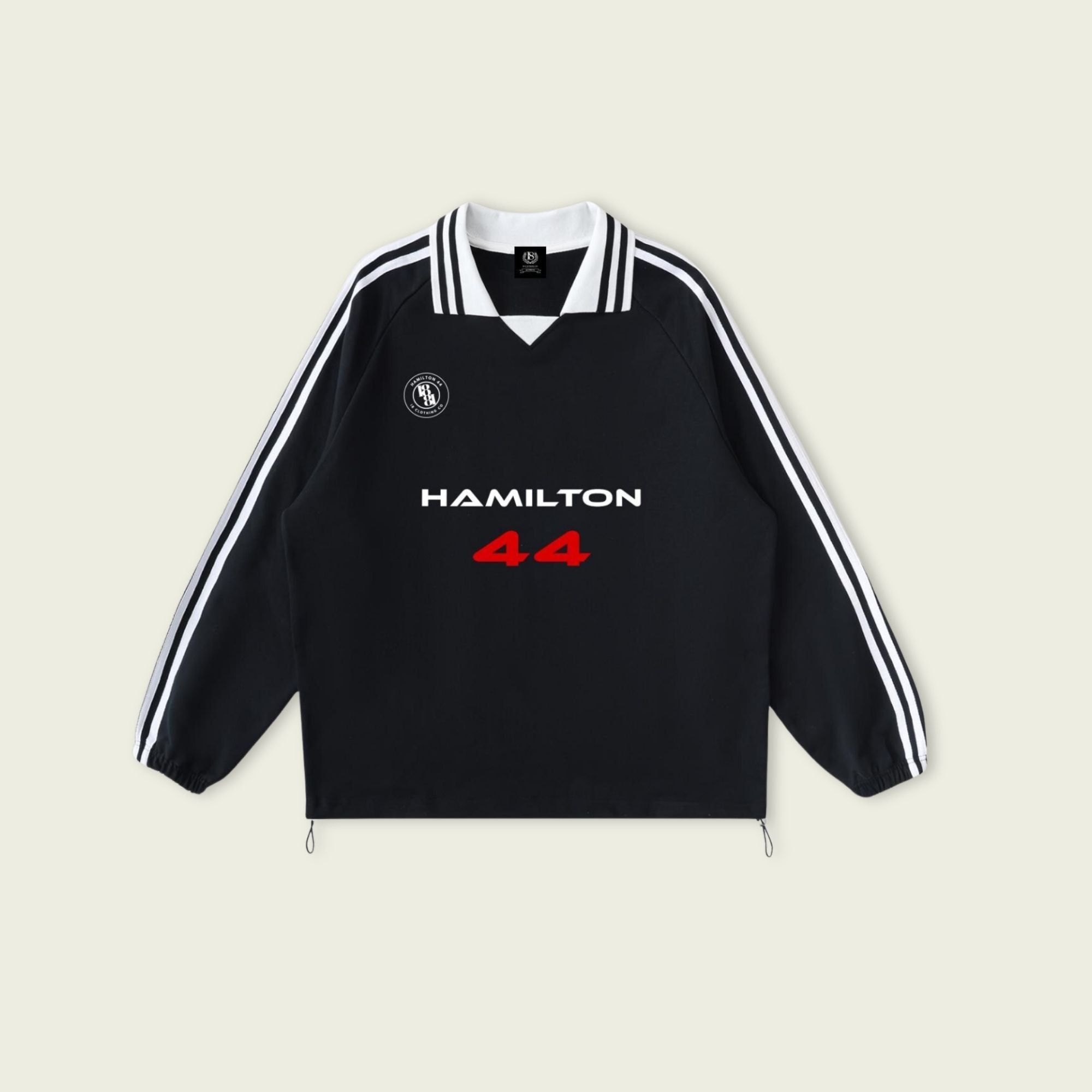 Black sweatshirt with 'Hamilton 44' text on a beige background