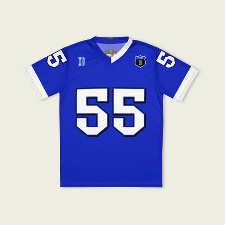 A blue and white football jersey with Carlos Sainz's Williams F1 racing number 55 on the back and front in white. It has the name sainz in white on the front and back as well.