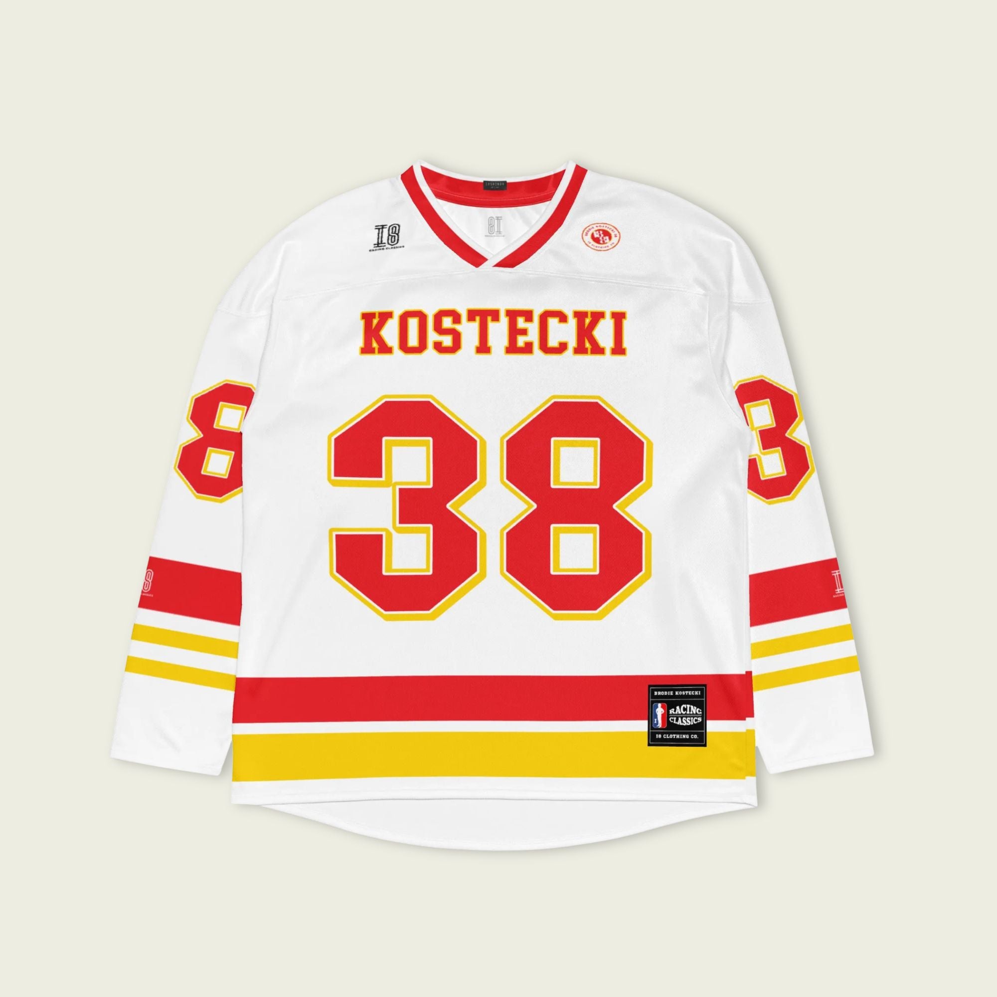White hockey jersey with red and yellow accents featuring the name 'Kostecki' and number '38'.
