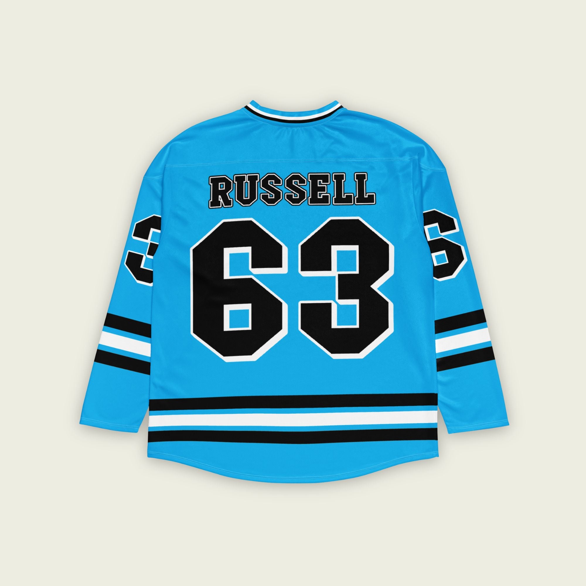 A blue hockey jersey with three stipes on the bottom the middle one is white and the bottom and top are black. It has the number 63 that George Russell races with in F1 that is filled with black and a white outline, it is displayed on the back and front. Also there is text on the front and back