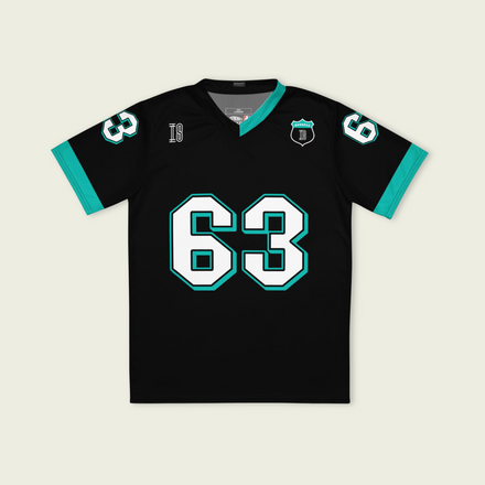 A black and AMG Green football jersey with George Russell's Mercedes F1 racing number 63 on the back and front in white. It has the name Russell in green on the front and back as well.