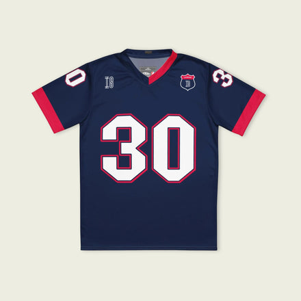 A navy blue and red football jersey with Liam Lawson's Redbull  F1 racing number 30 on the back and front in white. It has the name Lawson in white on the front and back as well.