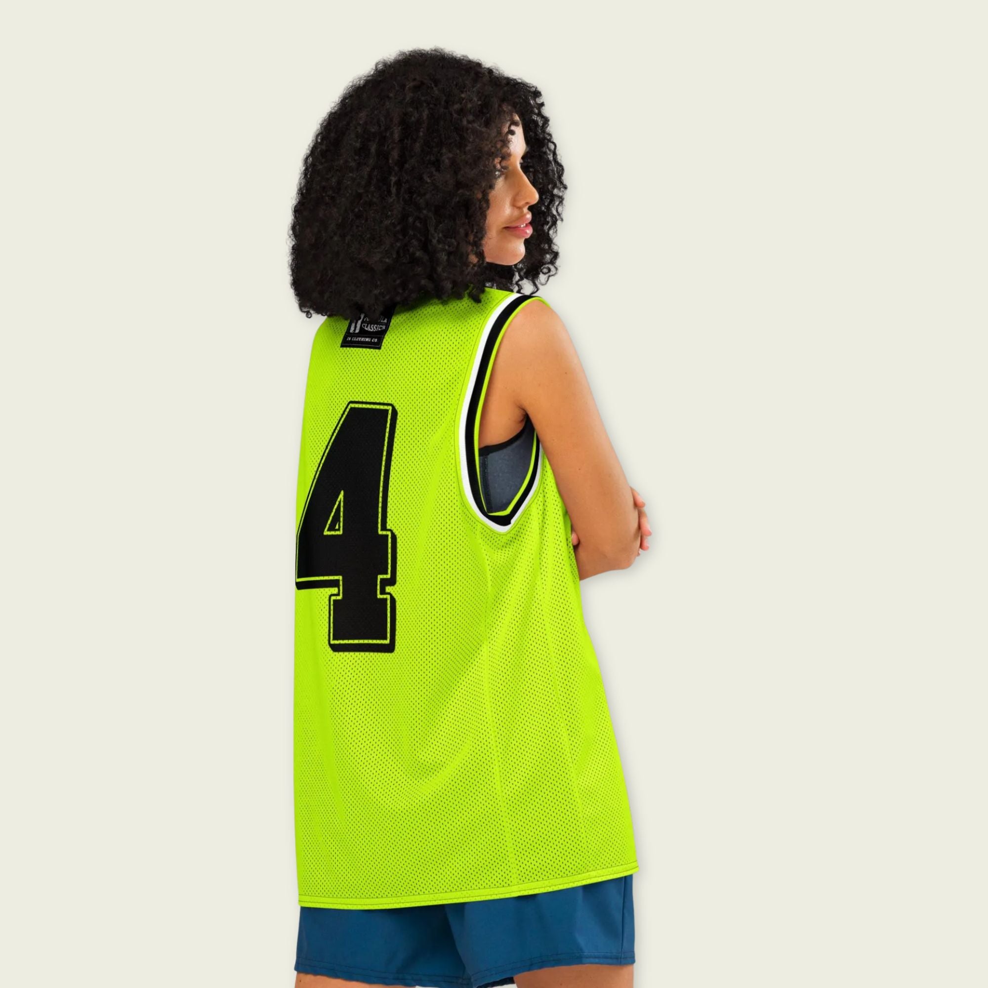 A neon green and black basketball Jersey with Lando Norris's McLaren F1 racing number 4 in balc and white on the back.