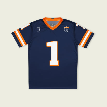 A Navy, orange and white football jersey with Mac Verstappen's Redbull F1 Racing number 1 on the front and back.