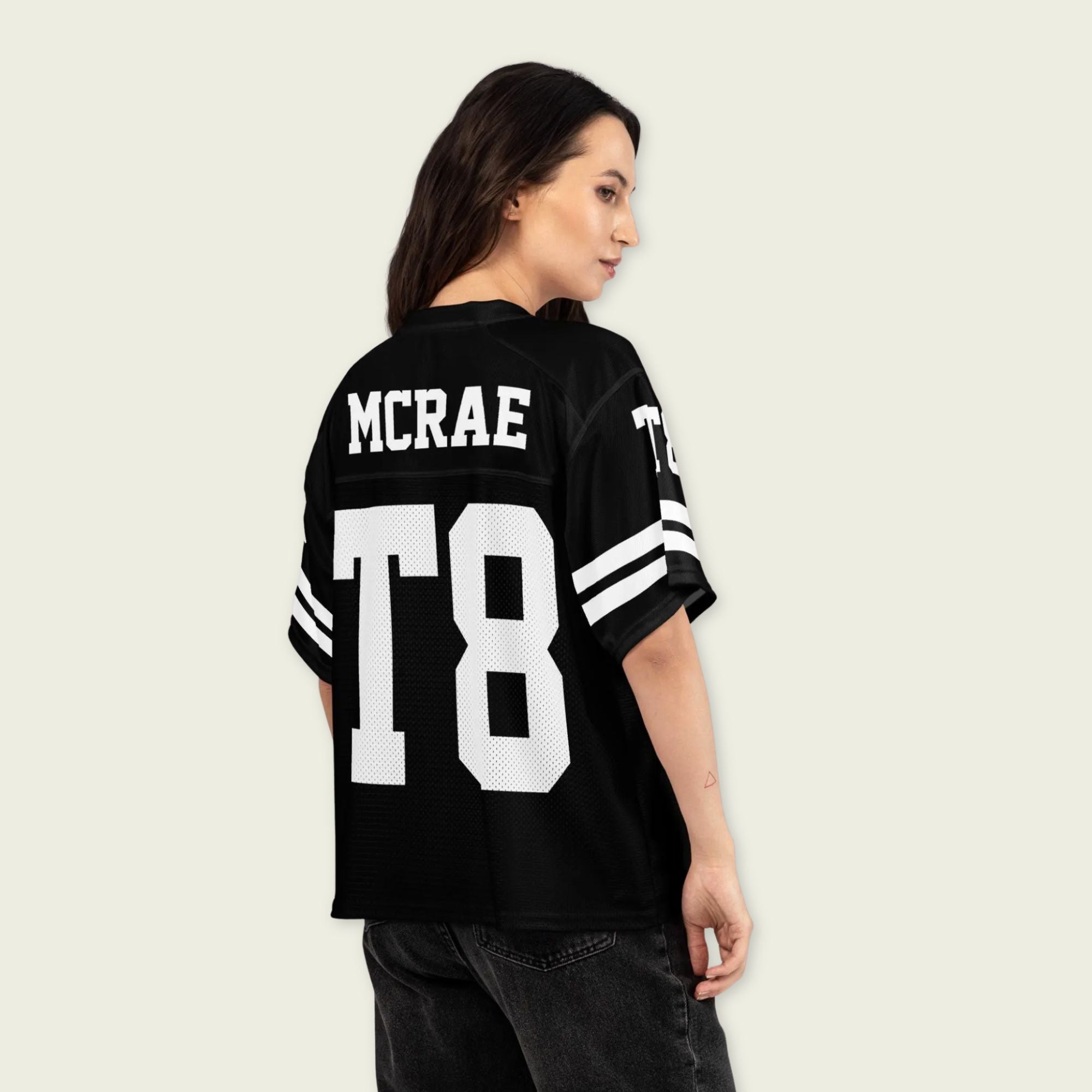 Person wearing a black sports jersey with 'MCRAE' and 'T8' printed on it, standing against a plain background.