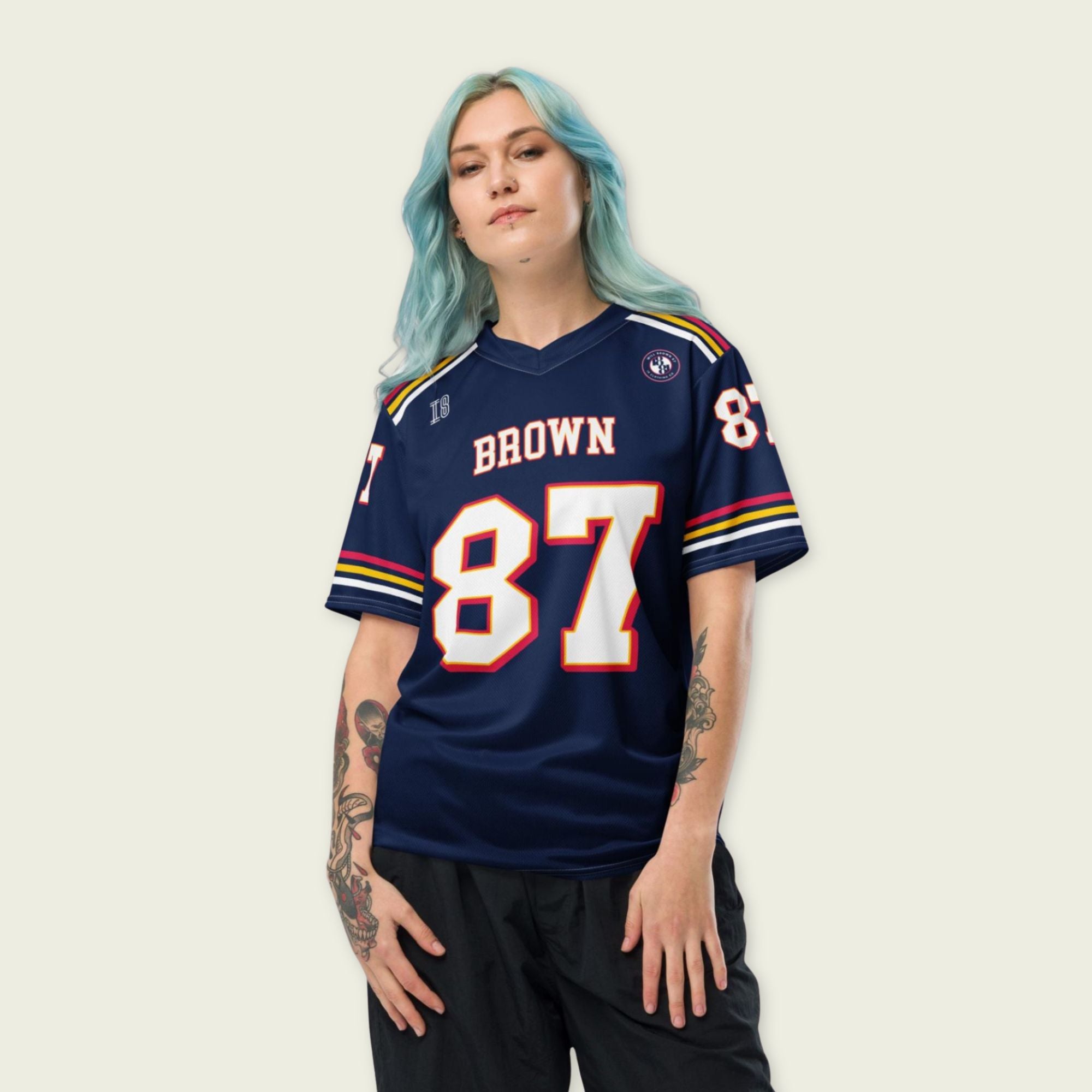 Person wearing a navy blue sports jersey with 'Brown' and number '87' on a plain background