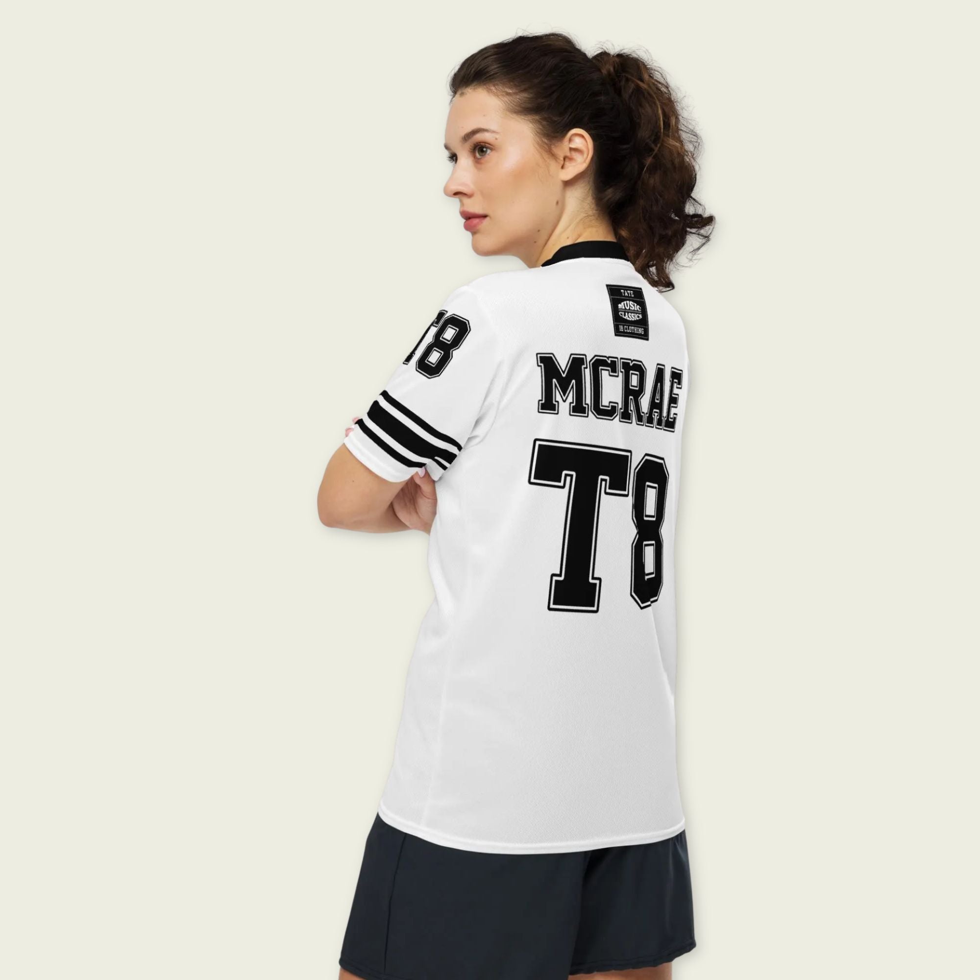 A black and white football jersey with Tate Mcare on the back and front in white with a white  outline.