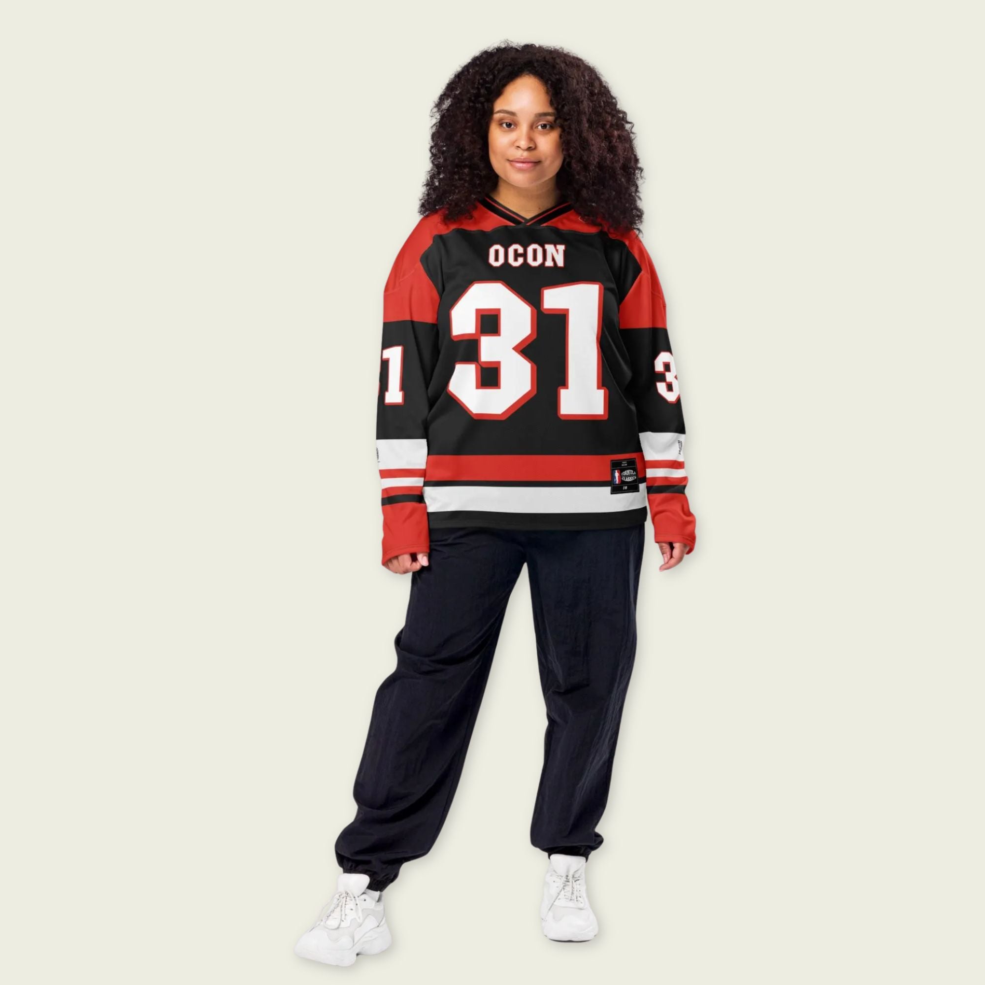 Person wearing a red and black sports jersey with 'OCON 31' on a beige background