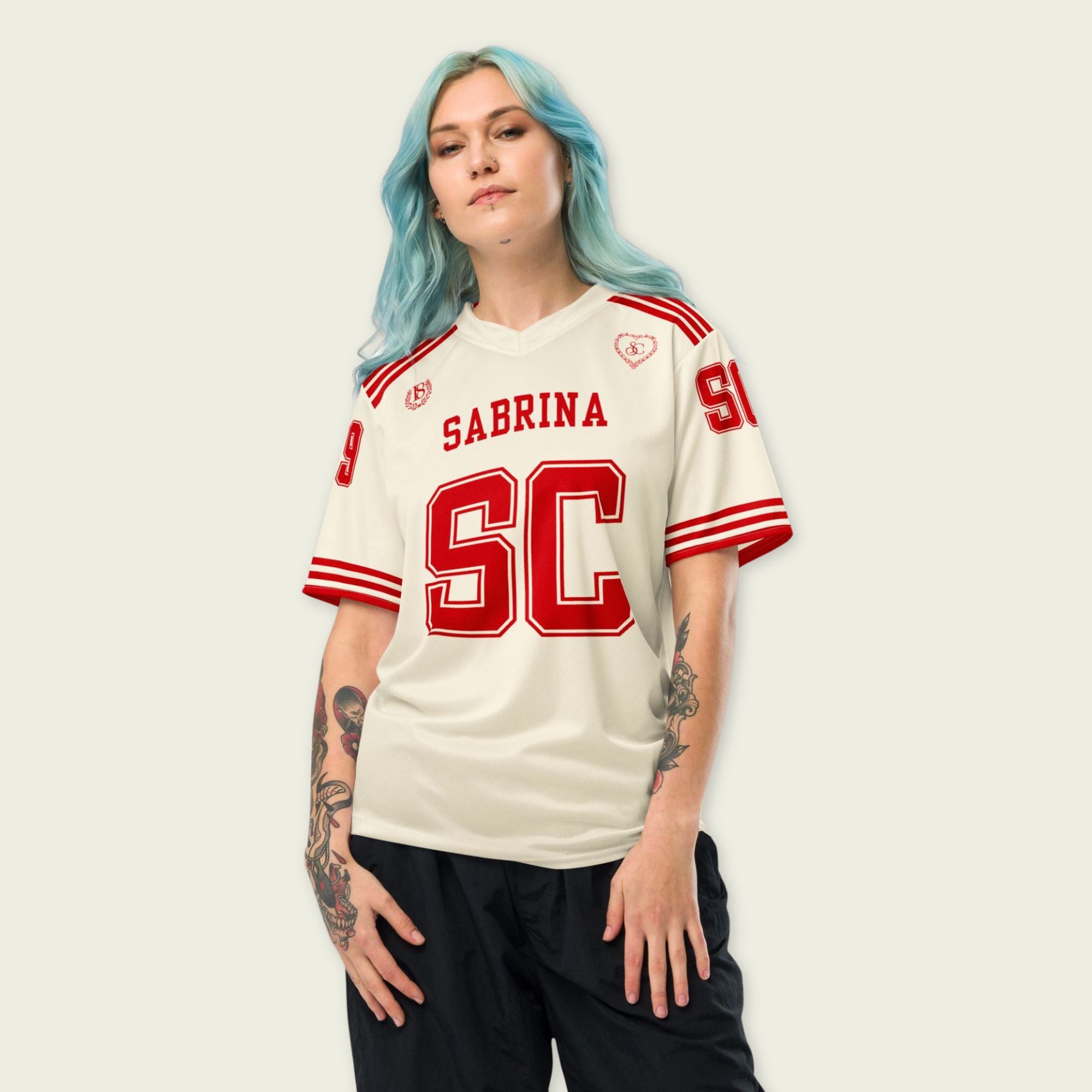 Person wearing a white sports jersey with red text and lettering on a plain background