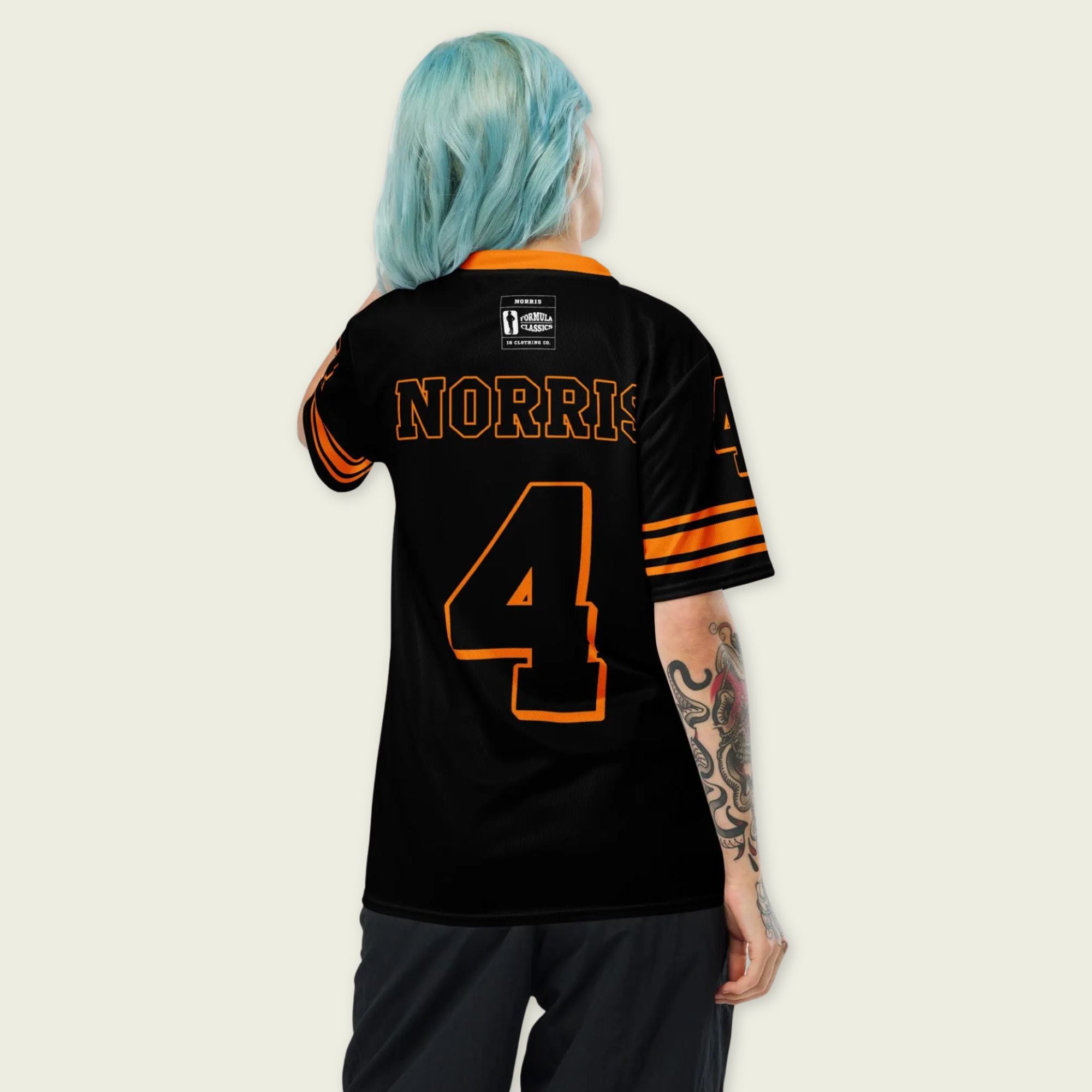 Person wearing a black sports jersey with 'Norris' and number '4' on the back, against a plain background.