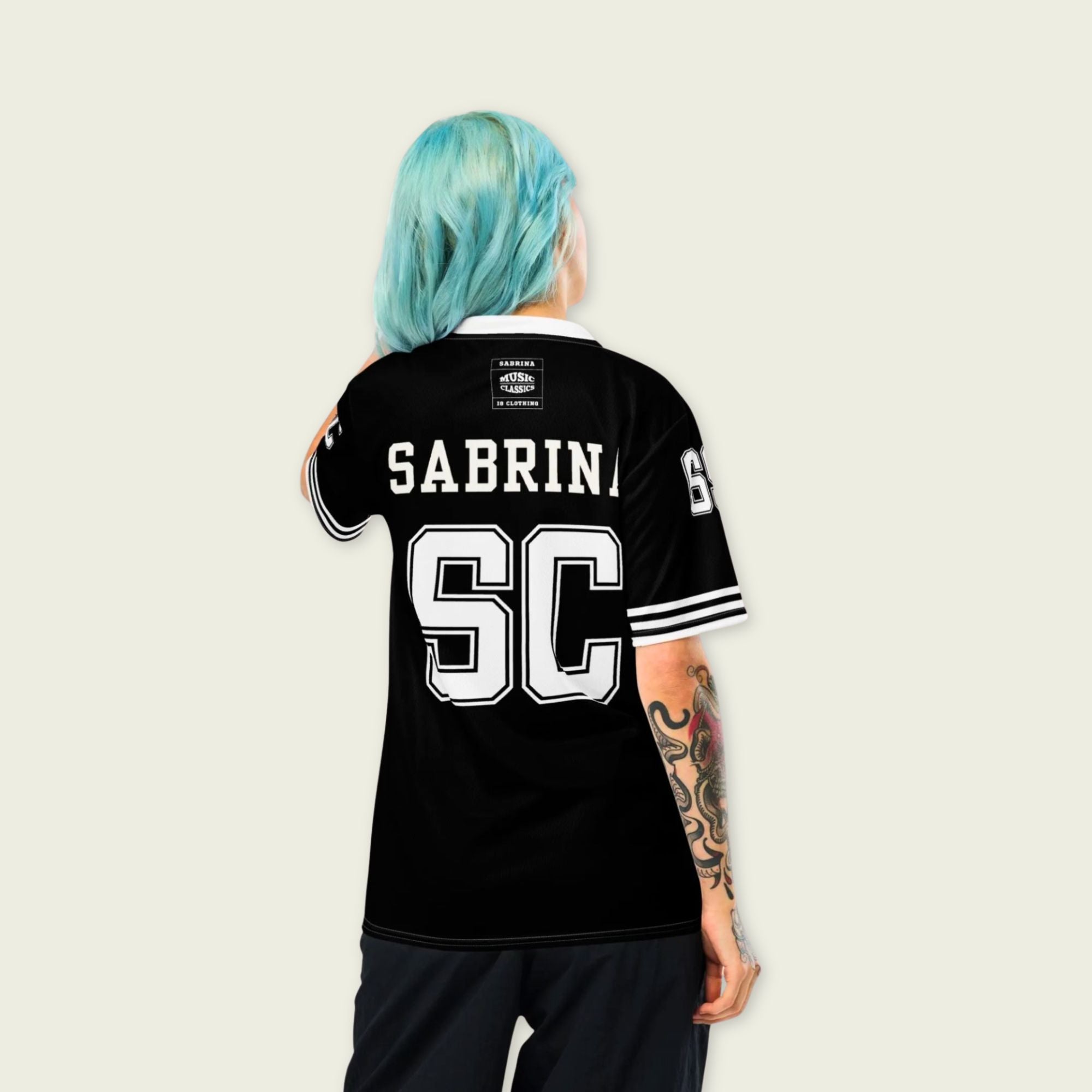 Person wearing a black sports jersey with 'Sabrina SC' on the back against a light background