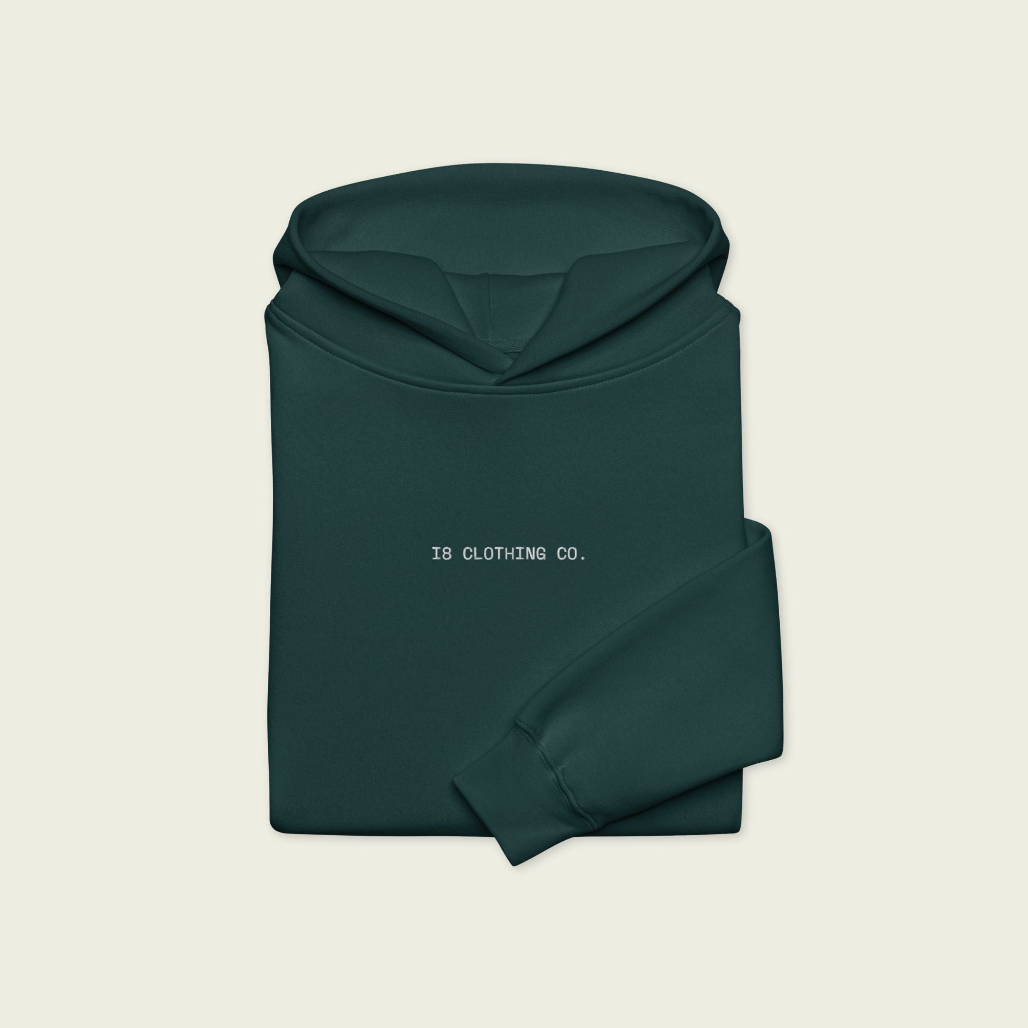 Dark green hoodie with '18 Clothing Co.' text on a beige background