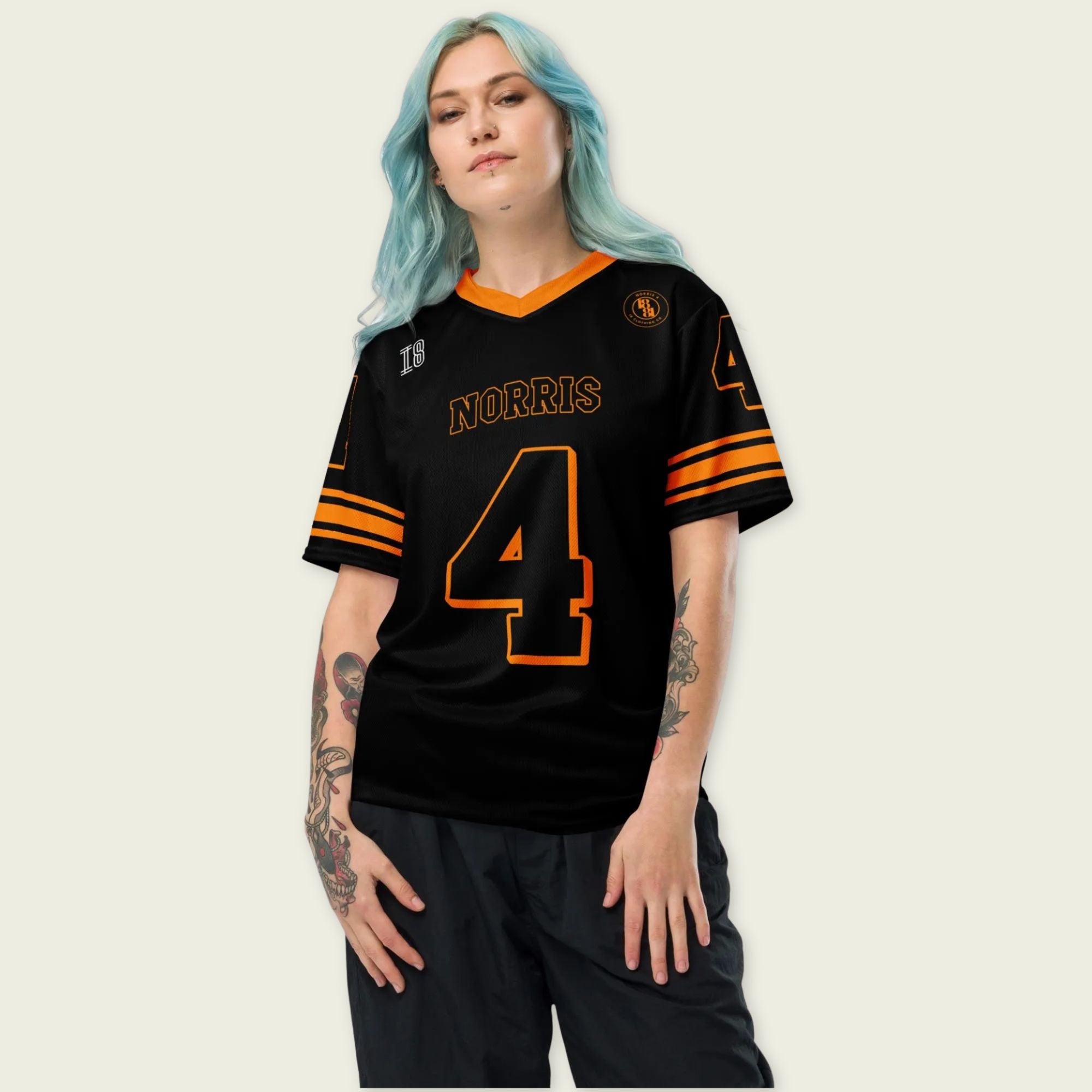 Person wearing a black sports jersey with orange accents and 'Norris' and number '4' on a plain background