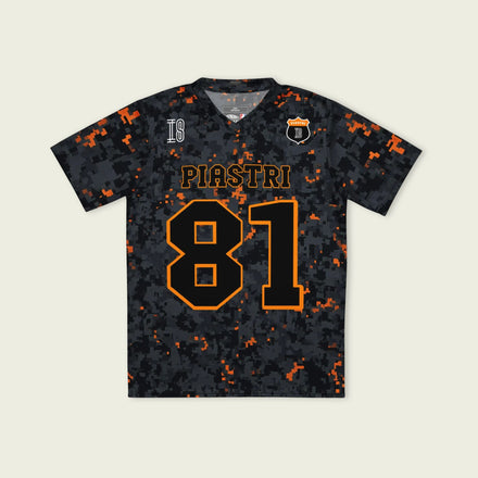 A camoflauge papaya orange football jersey with LOscar Piastri's McLaren  F1 Racing number 81 on the front and back.