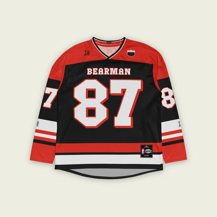 A red and black hockey jersey with Oliver Bearman's Haas F1 racing number 87 on the front and back in white, also the name Bearman is on the back and front in White.
