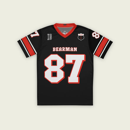 A black and red football jersey with Oliver Bearman's Haas F1 Racing number 87 in white on the front and back.