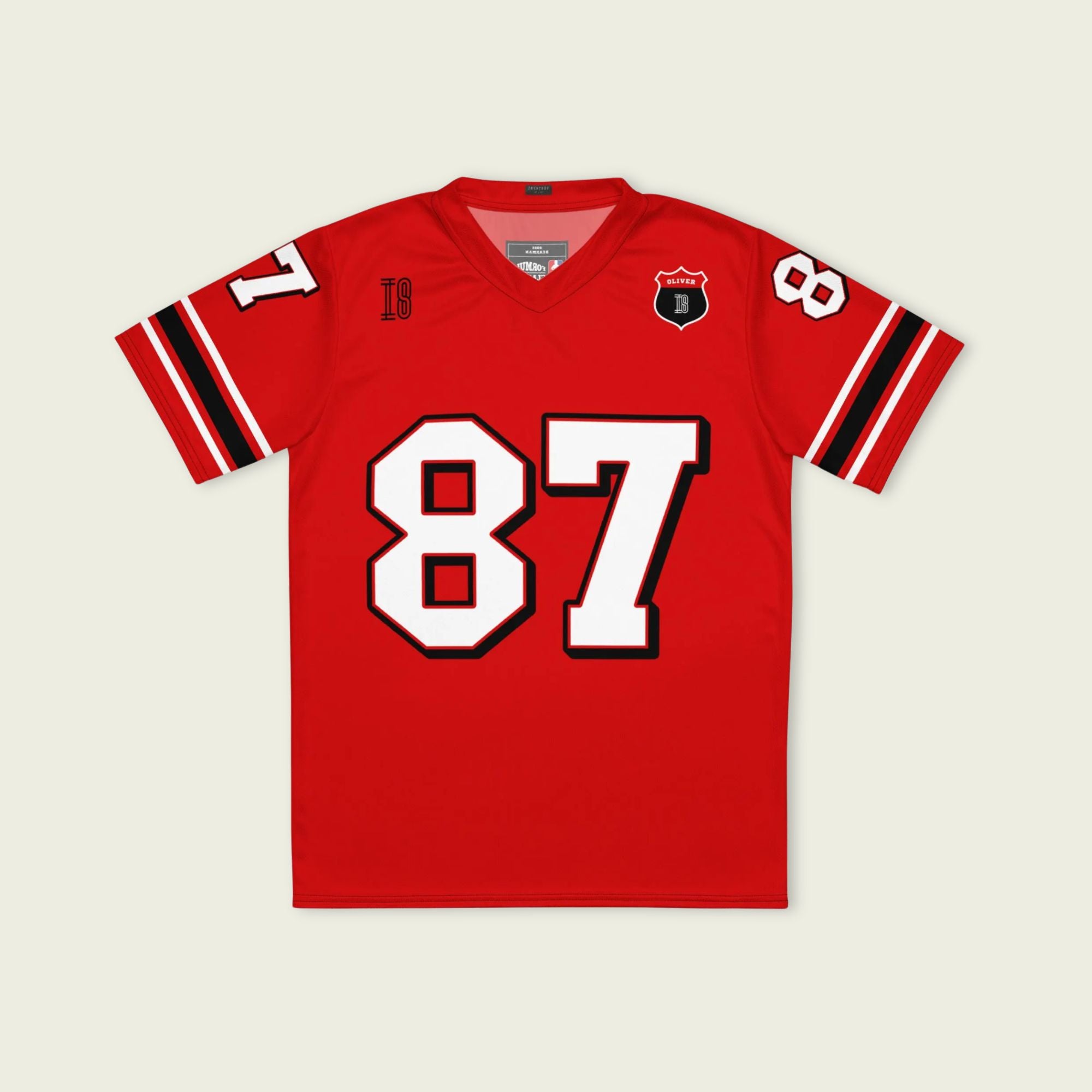 A red football jersey with Oliver Bearman's Haas F1 Racing number 87 in white on the front and back.