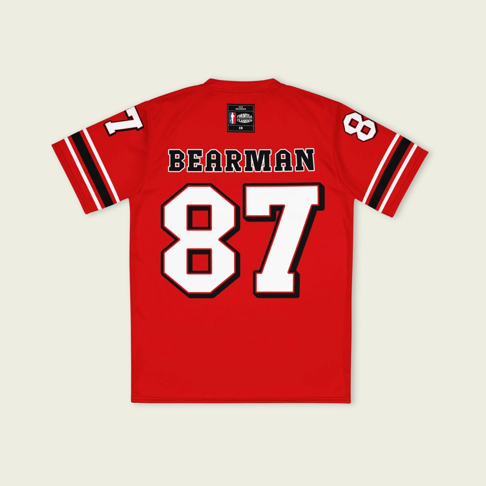 A red football jersey with Oliver Bearman's Haas F1 Racing number 87 in white on the front and back.