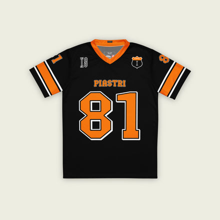 A black and papaya orange football jersey with Oscar Piastri McLaren F1 Racing number 81 in papaya orange on the front and back. The name Piastri is in orange on the front and back.