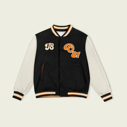 A black, papaya orange, and tan, varsity jacket with Oscar Piastri's McLaren F1 racing number 81 in orange on the front and back.