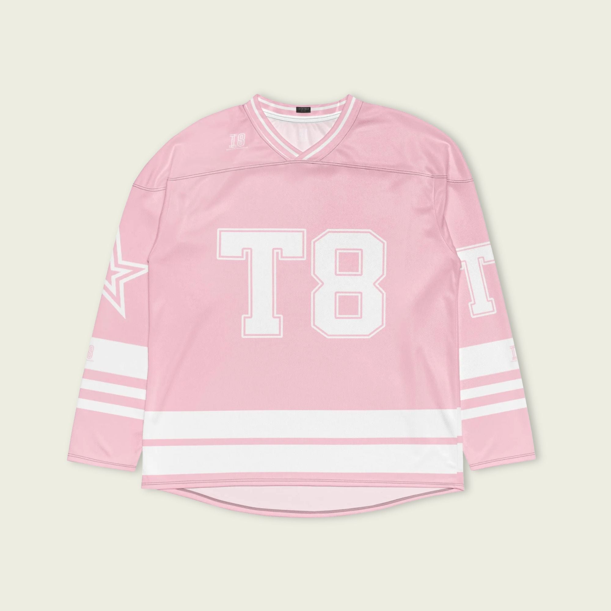 A pink and white hockey jersey with the name Mcrae in white on the front and back. Also T8 in white on the front and back.