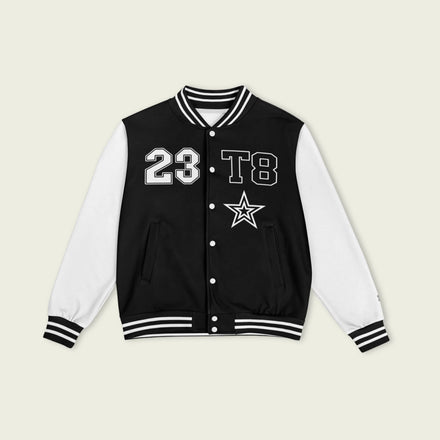 A black and white varsity jacket showing T8, 23, and Tate Mcrae in whte on the front and back.