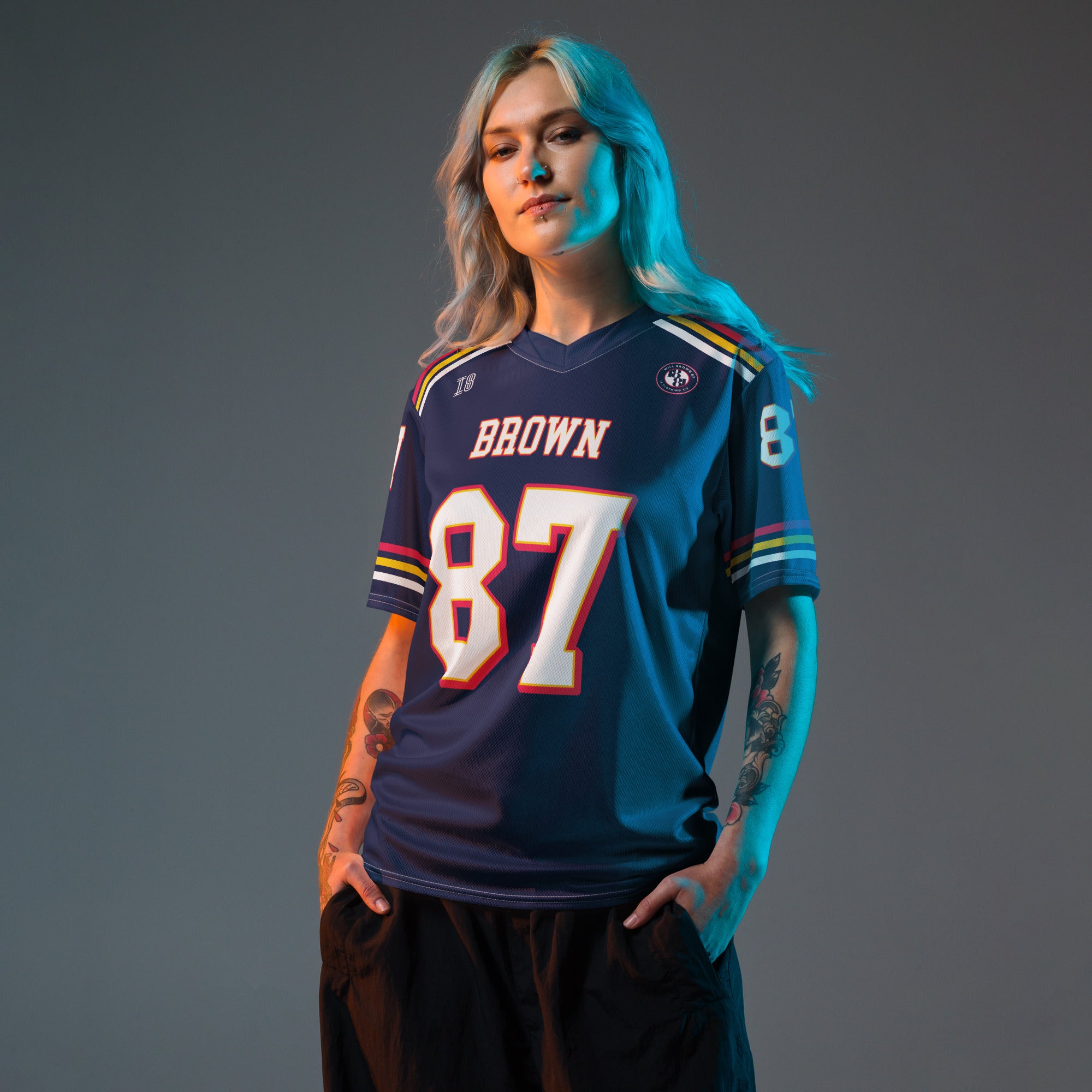 Person wearing a sports jersey with the number 87 on a gray background