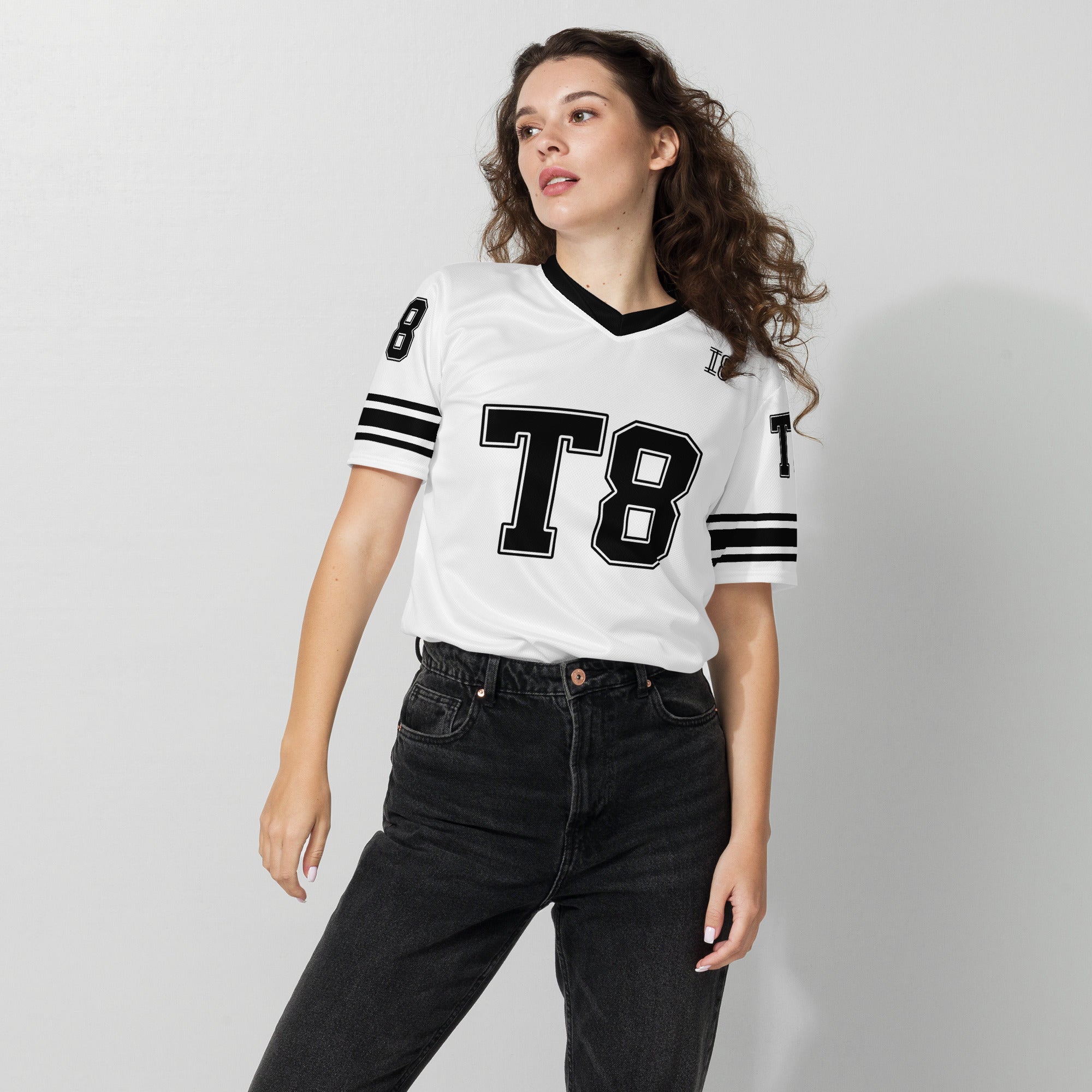 Woman wearing a white sports jersey with 'T8' on a plain background