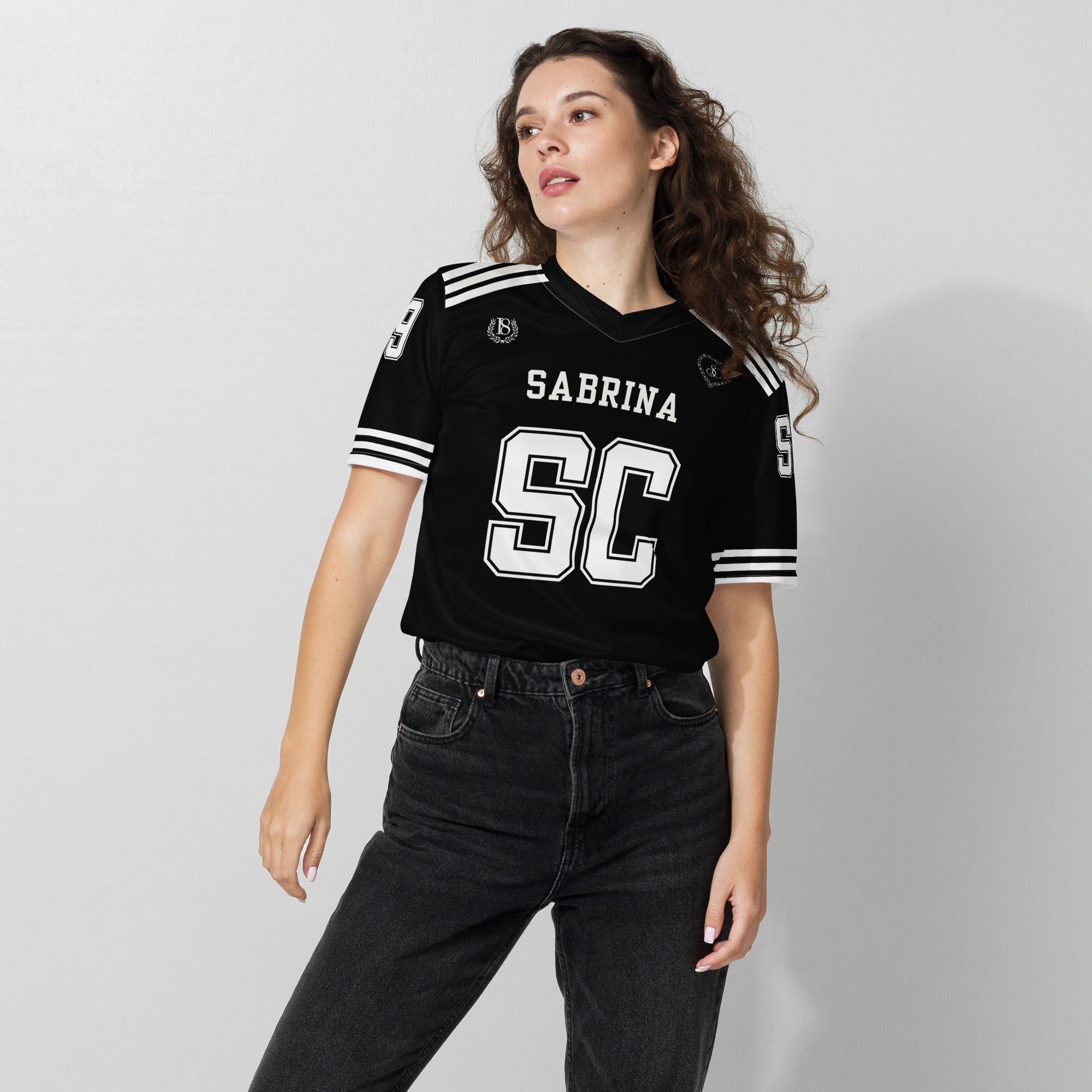 Woman wearing a black sports jersey with 'Sabrina SC' text on a plain background