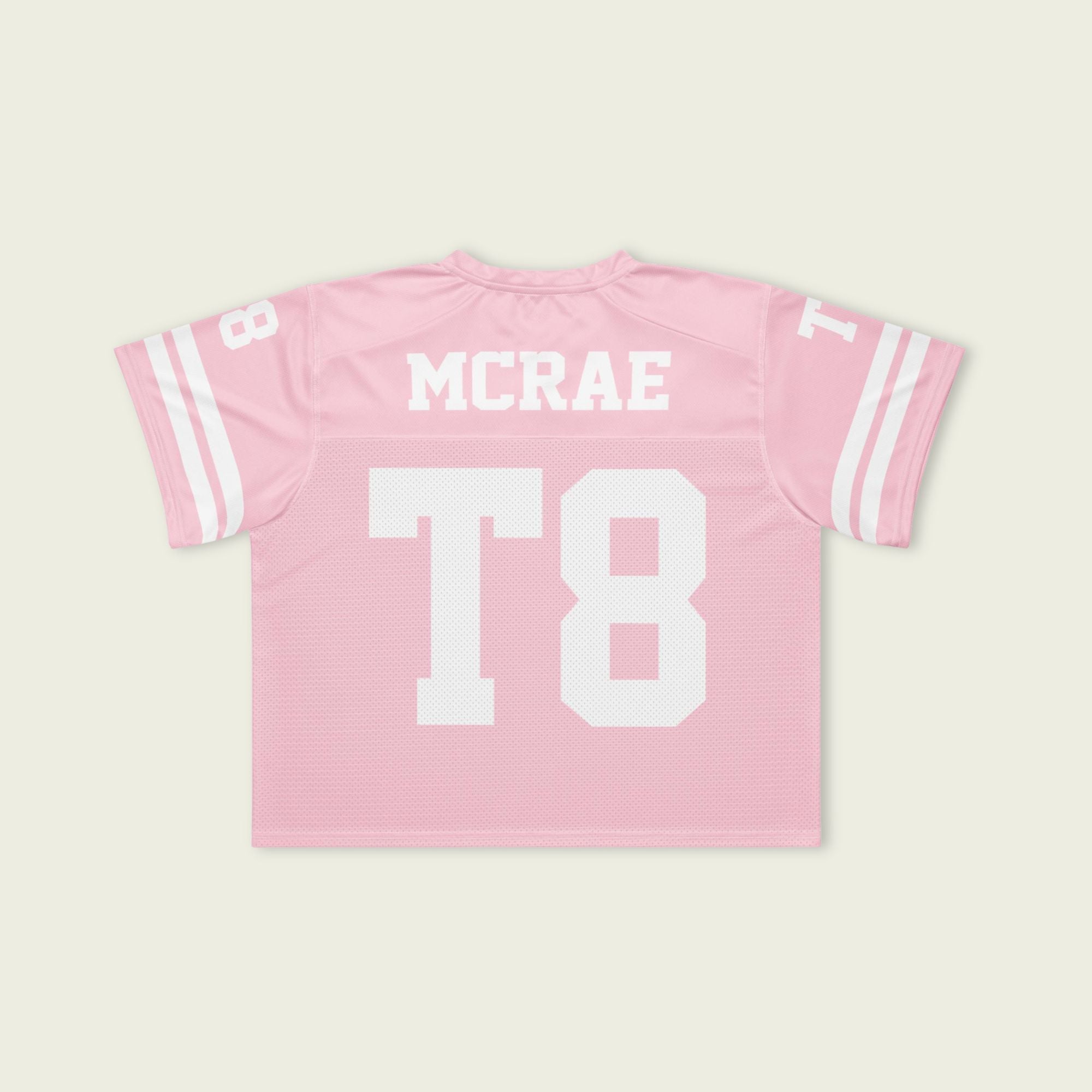 Pink sports jersey with 'MCRAE' and 'T8' printed on a light beige background