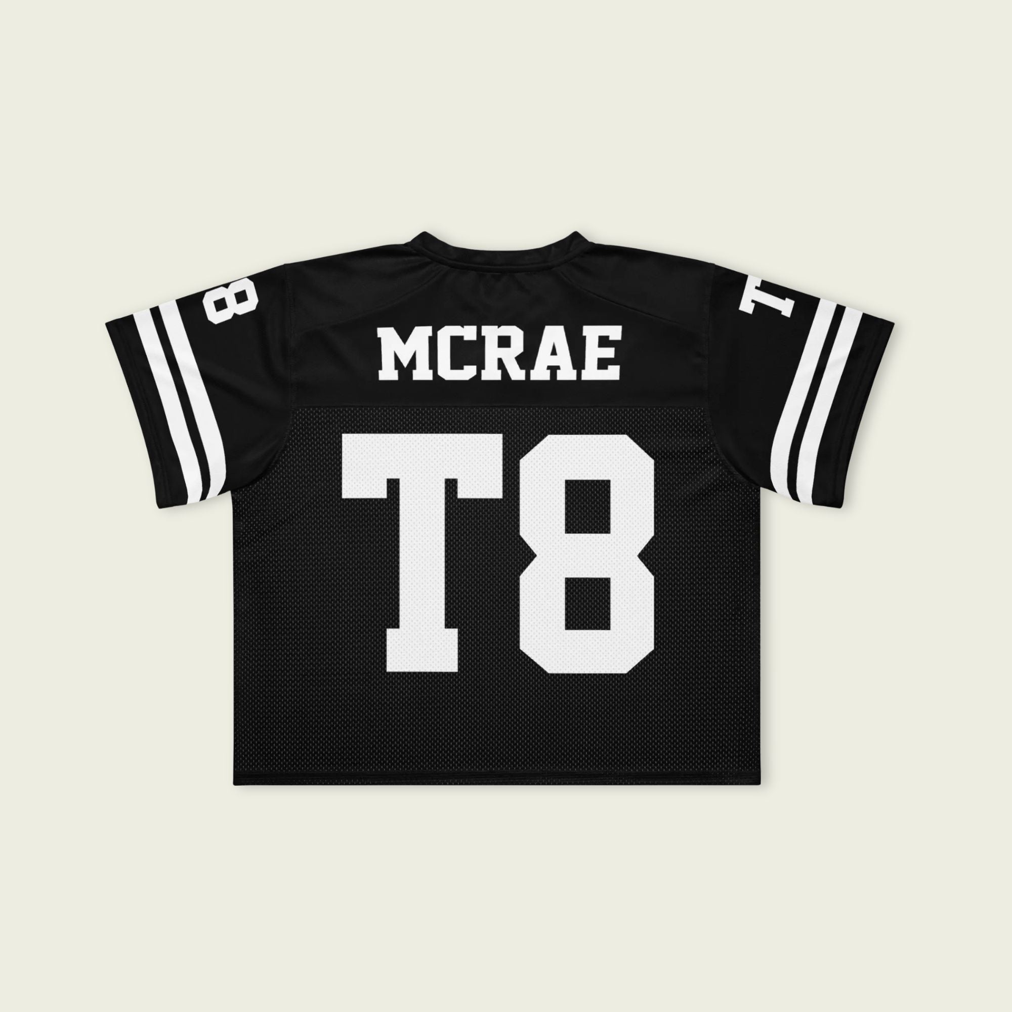 Black sports jersey with 'MCRAE' and 'T8' printed on a beige background