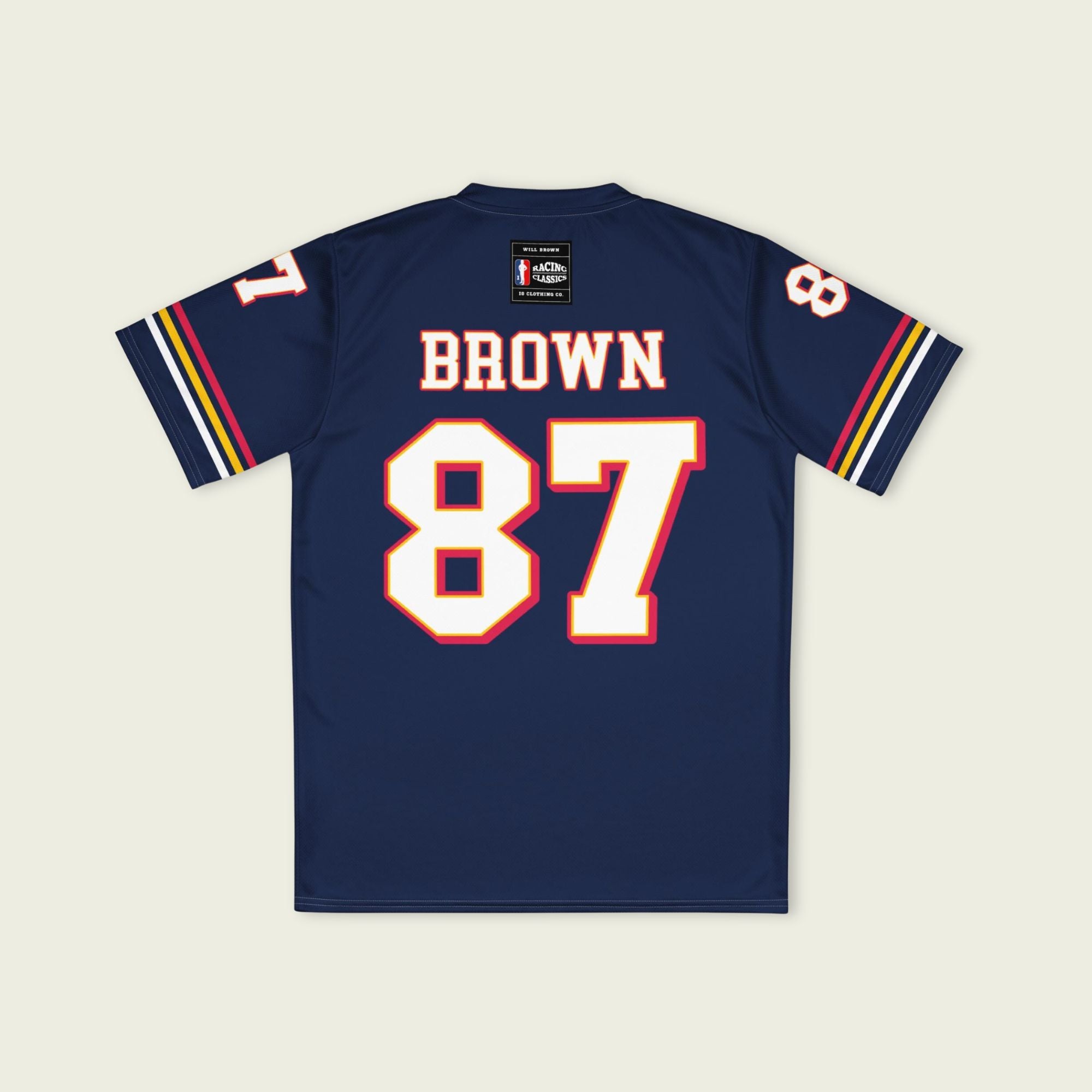 Navy blue sports jersey with 'Brown 87' printed on the back, displayed against a light beige background.