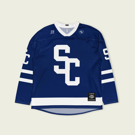 Blue sports jersey with white lettering on a light beige background
