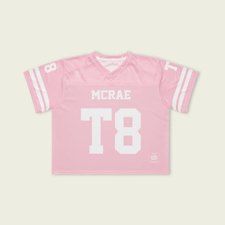 Pink sports jersey with 'MCRAE' and 'T8' printed on a light beige background