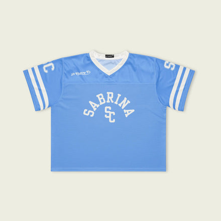 Blue sports jersey with 'Sabrina SC' branding on a beige background