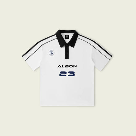 White polo shirt with black accents and 'Albon 23' branding on a light beige background