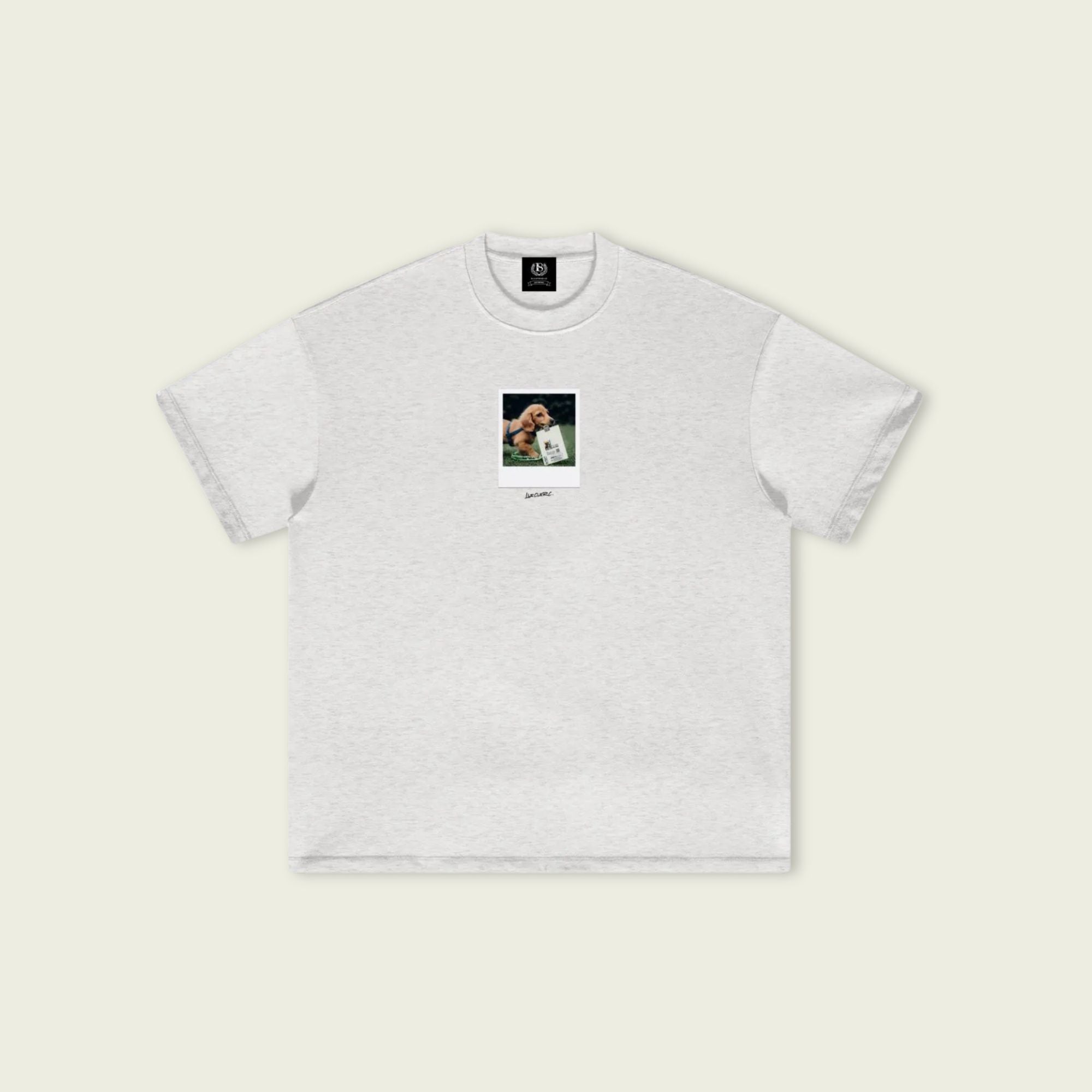 White t-shirt with a small graphic on a beige background